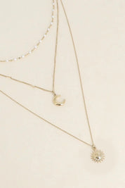Collier triple doré Nova - Bijou photographié sur fond beige