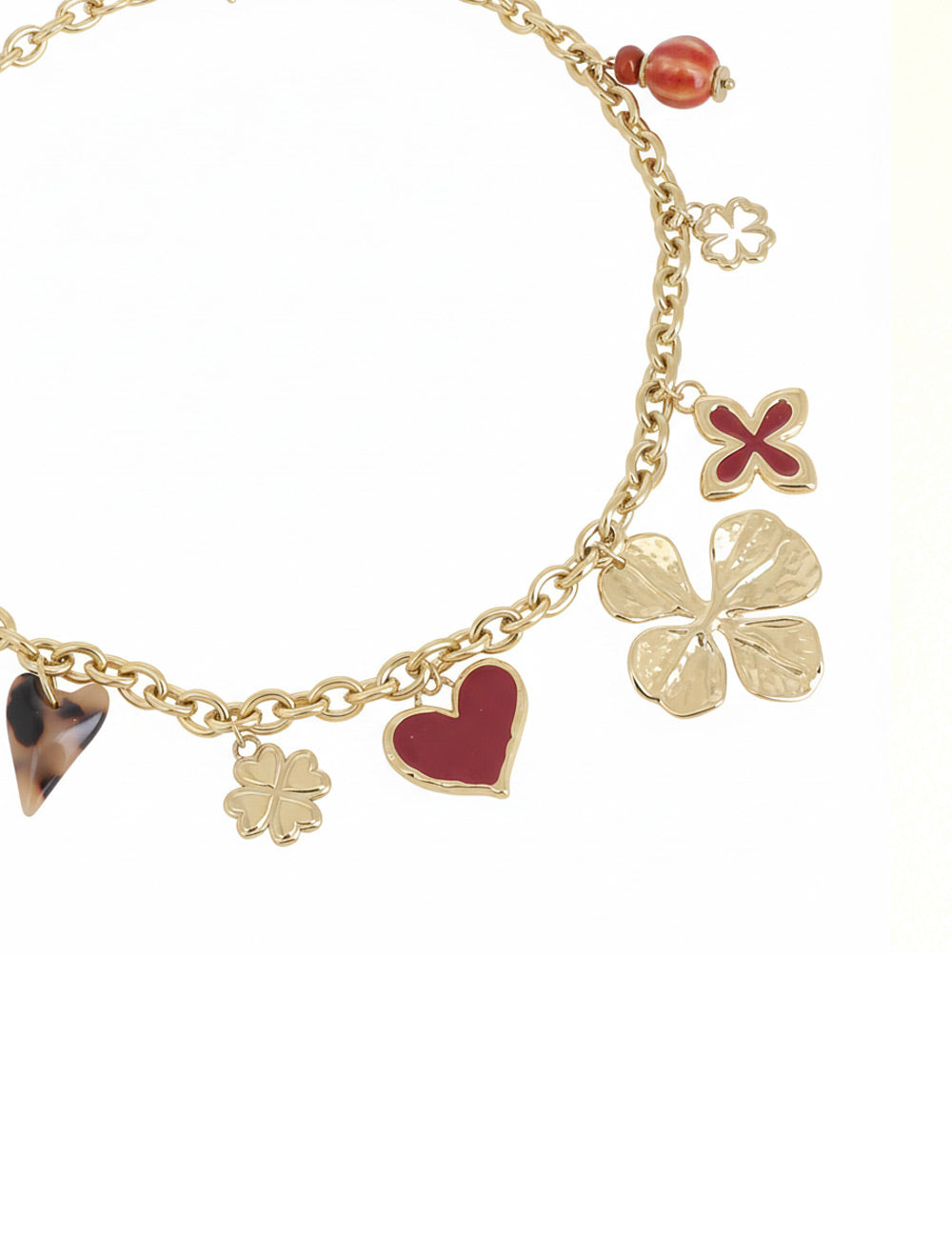 Collier doré Lounes maille avec pendentifs coeurs et trèfles - Bijou photographié sur fond blanc
